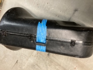 Airtag under painters tape, nestled by handle